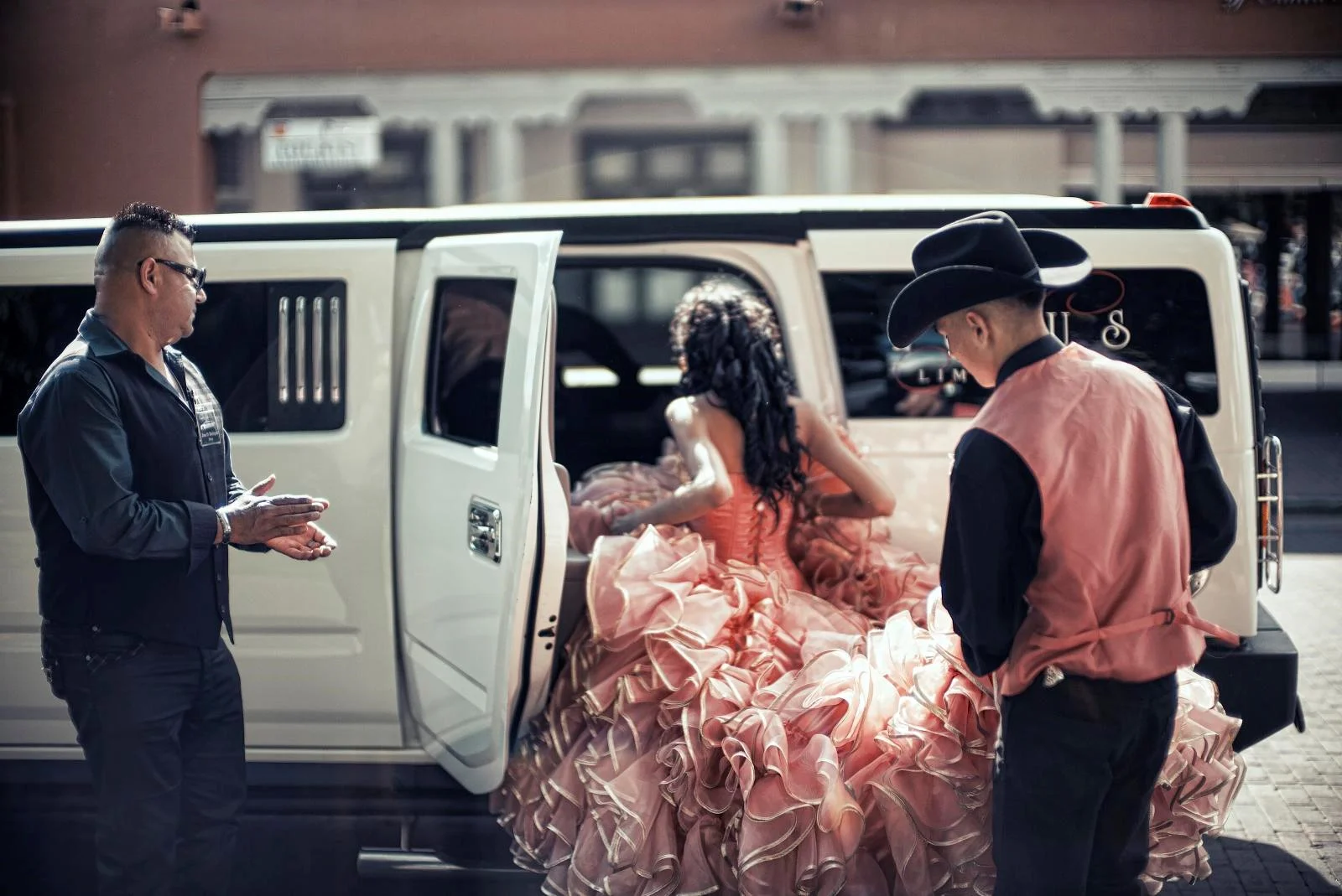 Quinceañera court arriving in a limousine